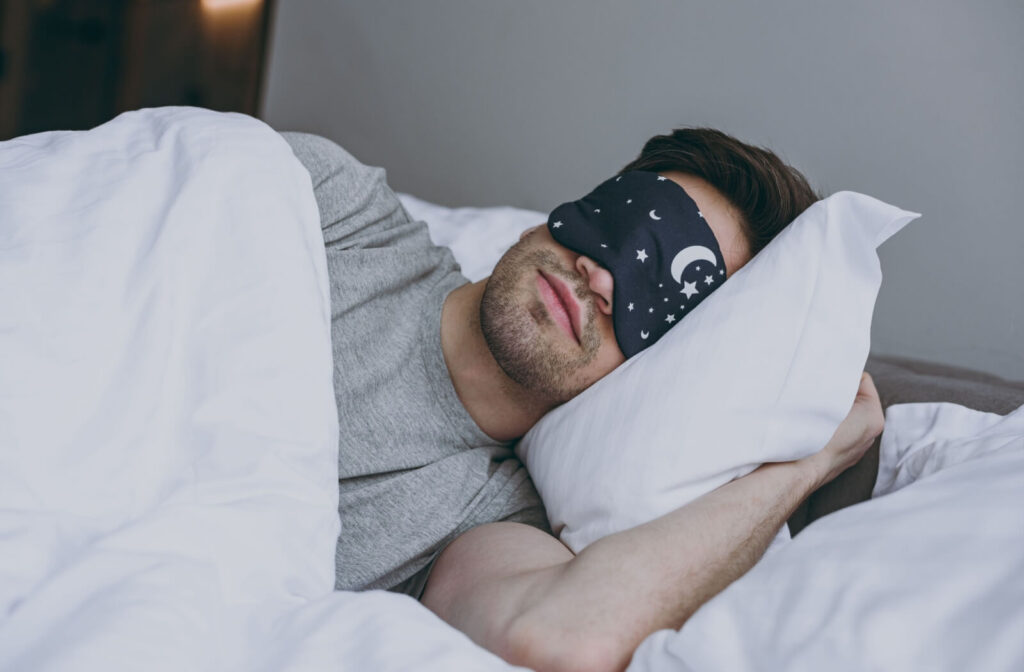 A person wears an eye mask to sleep, taking control of their sleeping environment.